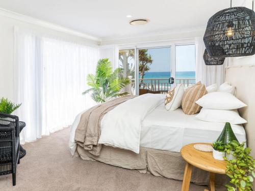 a bedroom with a bed with a view of the ocean at Absolute Beachfront Family Size Home in Gold Coast