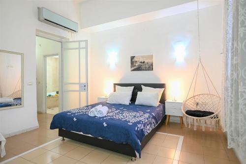 a bedroom with a bed with a blue comforter at Domos Tiberias דומוס טבריה in Tiberias