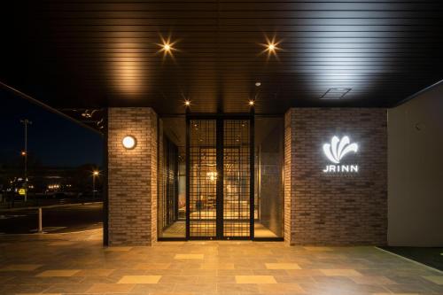 a building with a sign on the side of it at night at JR Inn Hakodate in Hakodate