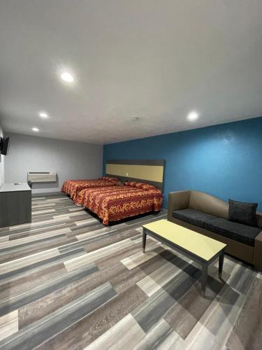 a hotel room with a bed and a couch at Casa Bell Motel, Los Angeles - LAX Airport in Inglewood