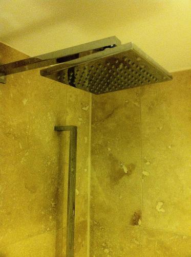 a shower in a bathroom with a metal vent at Bridge Hotel Brandon in Brandon
