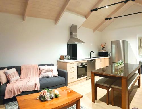 a living room with a couch and a table at The Alex Apartments in Queenstown