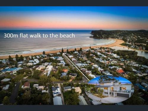 an aerial view of a beach with the words walk to the beach at North Avoca - Superior Beach Flat in North Avoca
