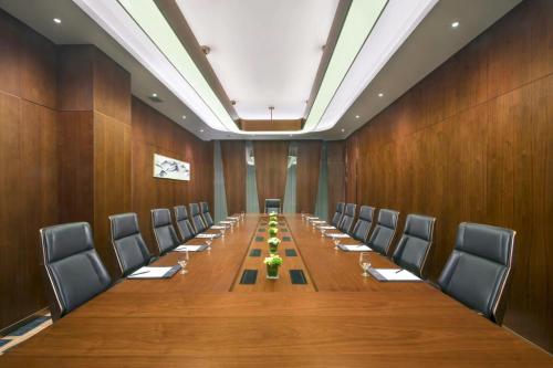 a large conference room with a long table and chairs at Novotel Changsha International Exhibition Center in Changsha