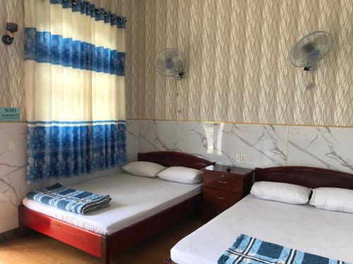 a room with two beds in a room at Hai Nam Guesthouse in Long Hai