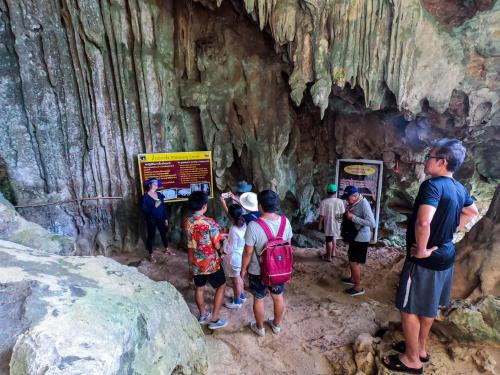 a group of people standing in a cave at 500 Rai Floating Resort in Ratchaprapha