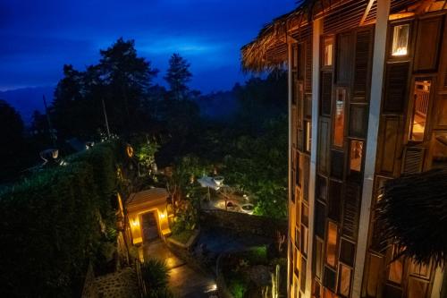 a view from a balcony of a building at night at Tira Vilagna Suites & Spa in Kintamani