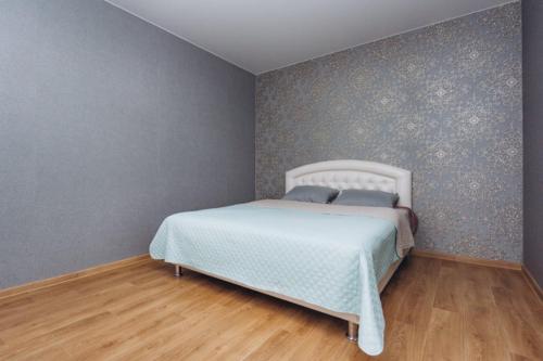 a bedroom with a white bed in a room at STAR HOME Прокофьева 16 корп2 in Sumy