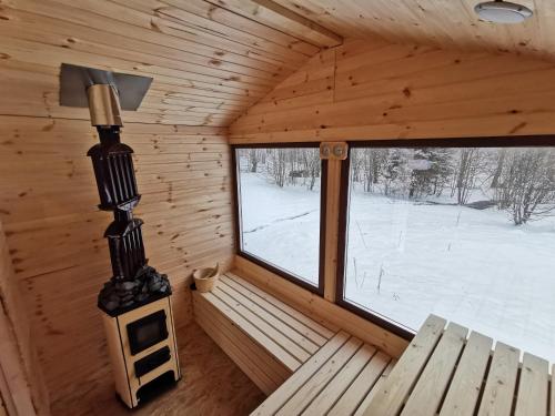 an inside view of a log cabin with a window at Pensiunea Ioana in Borlova