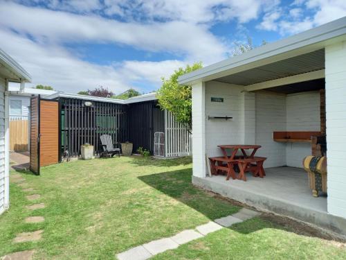 a backyard with a picnic table and a fence at Orford Escape in Orford