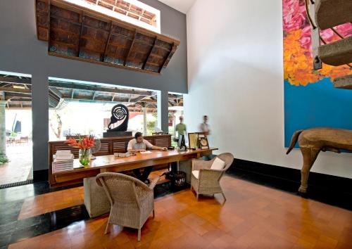 a person sitting at a table in a restaurant at Malabar House in Cochin
