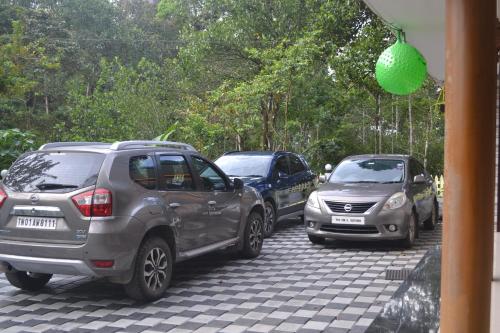 a group of cars parked in a parking lot at Arabian Nights Munnar Pool Villa in Munnar
