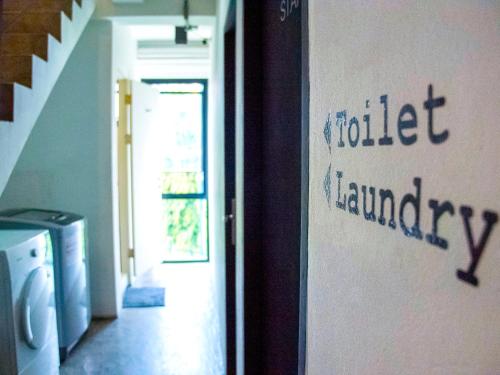 a hallway with a door to a house with aida laundry at HOLY SHEET Hostel in Bangkok