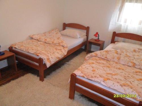a bedroom with two beds and two night stands at Apartments Sara in Žabljak