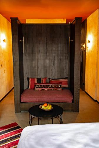 a red couch in a room with a table at Carus Cappadocia in Goreme