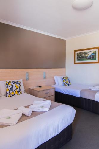 a room with two beds with towels on them at Kite Street Units - Contactless Check in in Orange