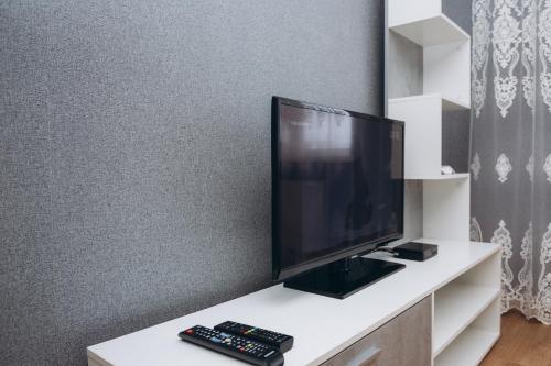 a flat screen tv sitting on top of a white table at STAR HOME Прокофьева 16 корп2 in Sumy