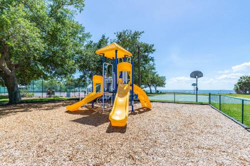 a playground with a yellow slide in a park at The Blue Lagoon in Ruskin
