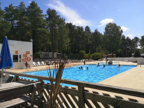 a large swimming pool with people in it at Camping La Dune Blanche - Daly's home in Camiers