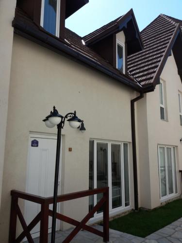 a house with a street light in front of it at Ema A2 Kraljevi Čardaci in Kopaonik