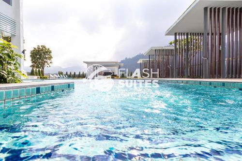 a swimming pool in front of a building at Windmill Upon Hills Premium Suites Genting Highland in Genting Highlands