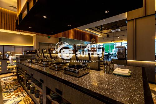 a restaurant with a counter with a sign on it at Windmill Upon Hills Premium Suites Genting Highland in Genting Highlands