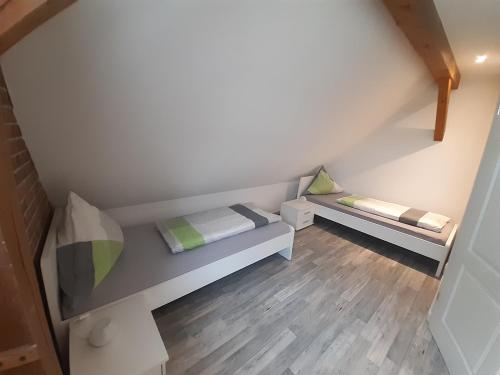 a small room with two beds in the attic at Ferienhof Altes Land in Jork