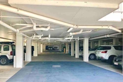 an empty parking lot with cars parked in it at Ocean View - Alexandra Headlands Beachfront Unit in Alexandra Headland