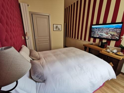 a bedroom with a white bed and a flat screen tv at Chalet Lucca in Lucca