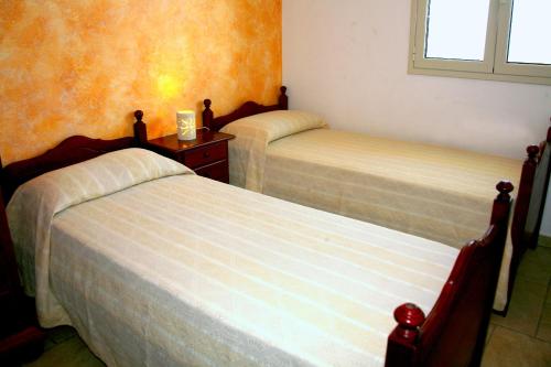 a bedroom with two beds and a window at Cuore di mare SALENTO - Beach House for Families in Torre Pali 