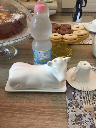 a table with a jug of milk and a plate with a bottle of water at Xenia Home in Reggio Calabria