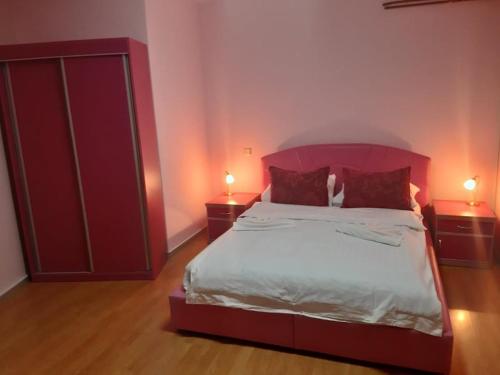 a bedroom with a large bed and two night stands at Apartmani Nikola in Vrnjačka Banja