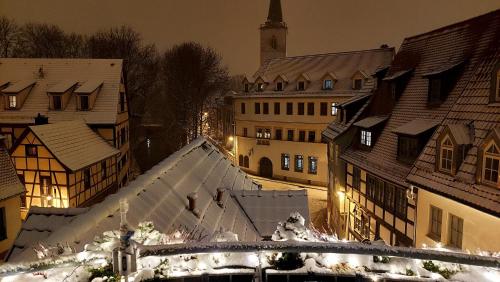 an old town at night with snow on the roofs at Altstadtapartment an der Krämerbrücke Nr.2 in Erfurt