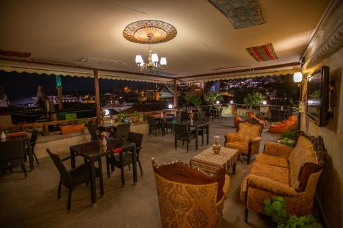 a dining room with tables and chairs and a restaurant at Stone House Cave Hotel in Goreme