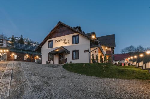 a building on a gravel road in front of a building at Pieninski Mak. in Szczawnica