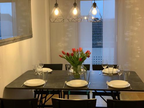 a dining room table with a vase of flowers on it at Casa Catalina in Rust