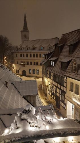 a view of a snowy town at night with a church at Altstadtapartment an der Krämerbrücke Nr.2 in Erfurt