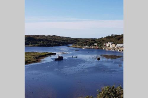 a river with two boats in the water at The Loft @ Clifden Bay Apartments in Clifden