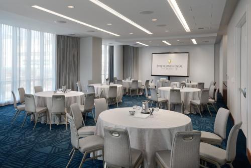 a conference room with tables and chairs and a screen at InterContinental San Francisco by IHG in San Francisco