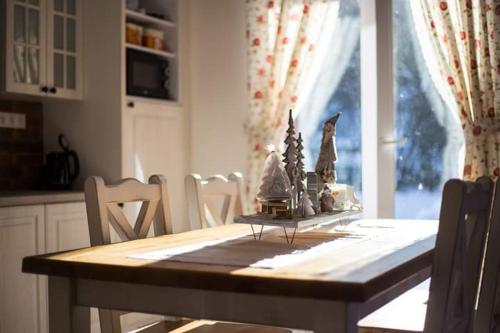 a dining room table with christmas decorations on it at Domčeky Sabinka a Melinka in Valča