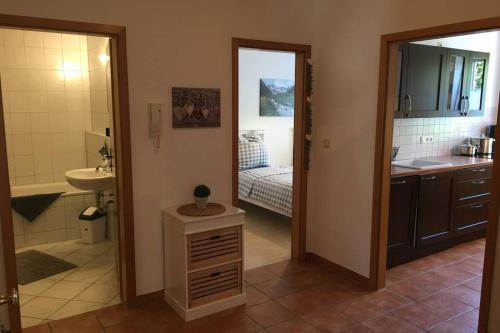 a kitchen with a sink and a bathroom with a sink at Allgäutraum Ferienwohnung Nr 10 in Kempten