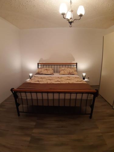 a bedroom with a bed with two candles on it at Holiday House Ivan in Donji Zemunik
