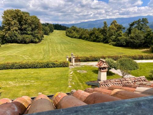 an aerial view of a house with a field and trees at Fienile Chiaramada in Belluno