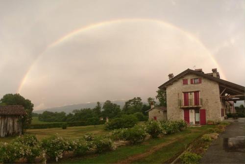 un arco iris sobre una casa con una casa en Fienile Chiaramada en Belluno