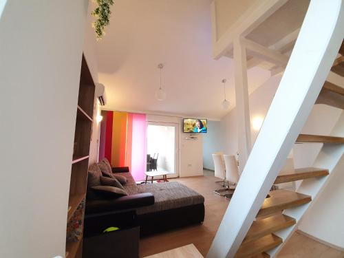 a living room with a couch and a colorful wall at Apartment Golden Sun in Vir