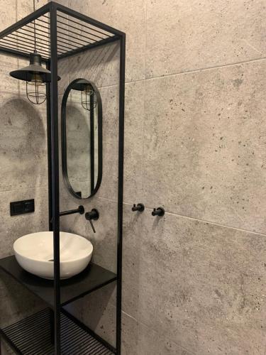 a bathroom with a sink and a mirror at Latarnia Wagabundy Bieszczady in Wola Michowa