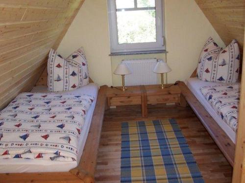 a room with two beds and a window at Zur alten Schmiede II (Haus I) in Boltenhagen