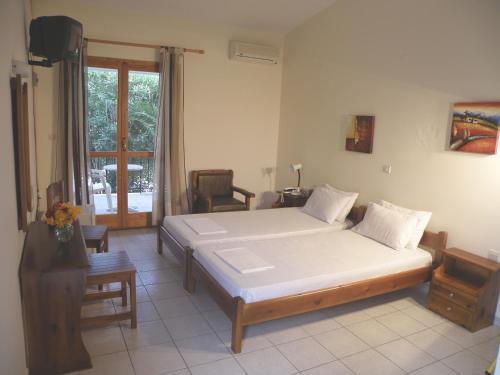 a bedroom with a large bed in a room at Hotel Petit Village in Eretria