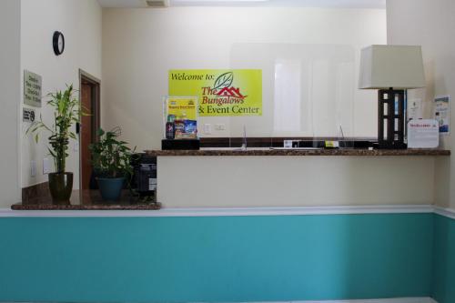 a room with a counter with potted plants on it at Texas Bungalows Hotel & Hotel Que at Lakeline Austin Cedar Park in Cedar Park