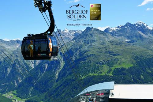 a gondola flying over a mountain range with mountains at Berghof Sölden - anno 1588 in Sölden